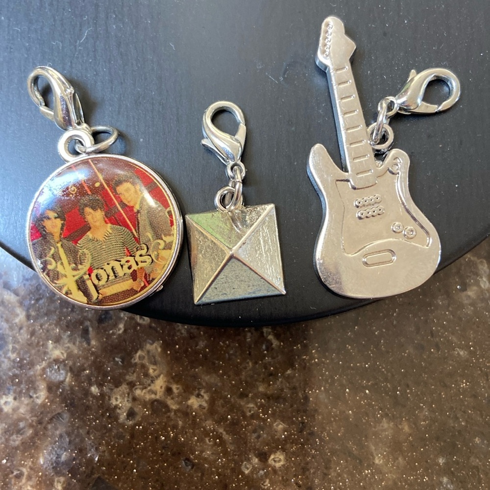 2 Disney charms guitar & pyramid silver
